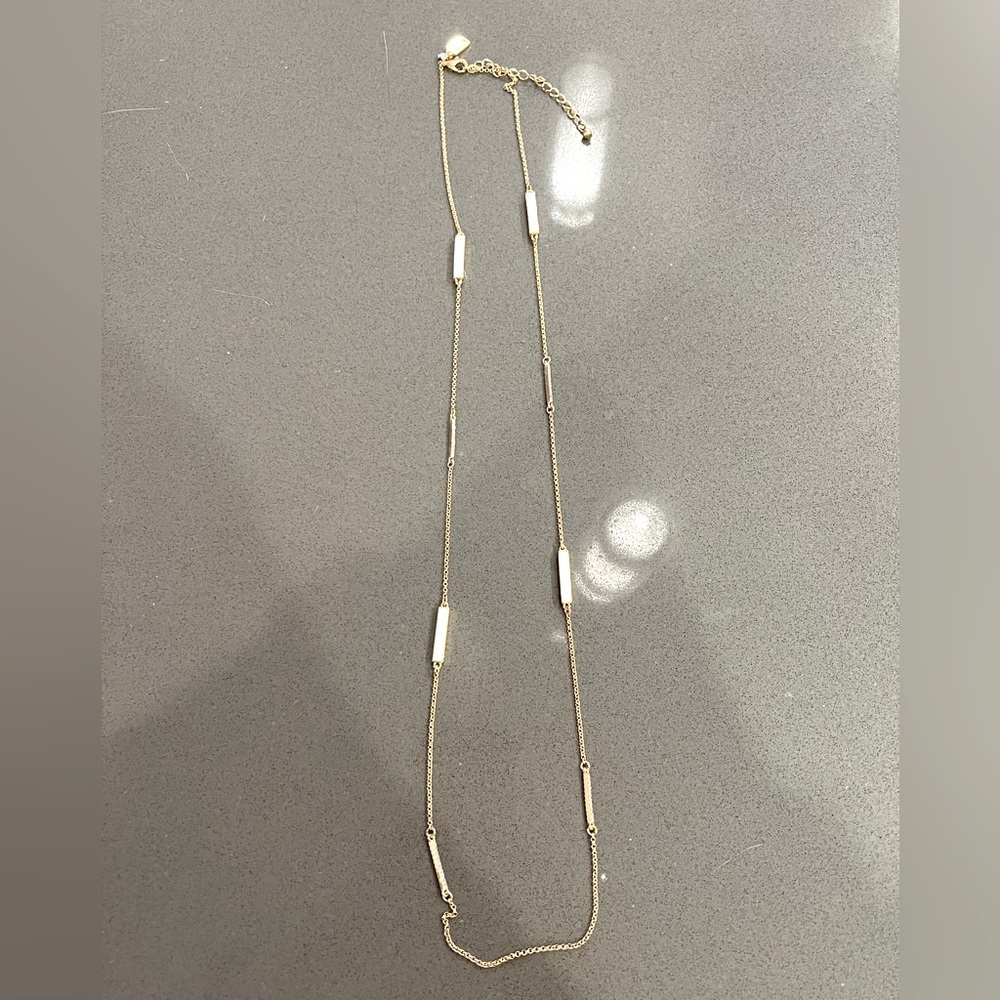 Kate Spade Gold long necklace with white bars and diamond bars.